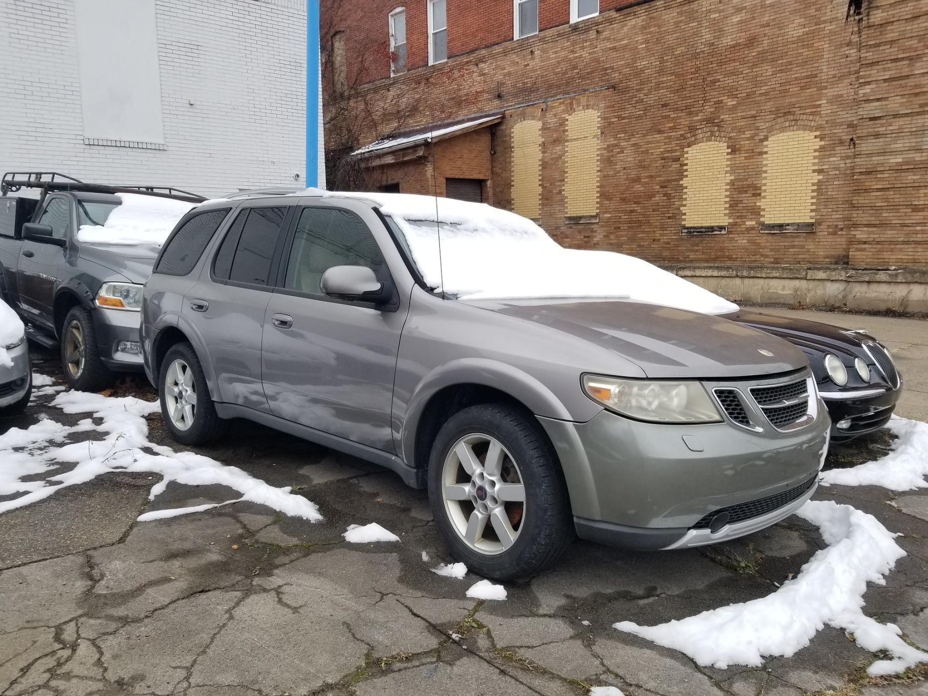Photo of a gray 2006 Saab 9-7X SUV in a parking lot covered with snow