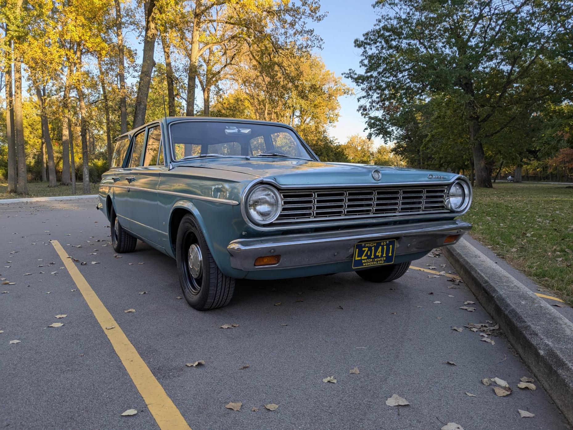 Picture of a blue 1965 Dodge Dart station wagon in an arboreal setting in autumn