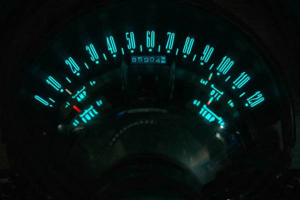 Blue-green instrument lighting of a 1960 Chrysler New Yorker, photographed in the dark